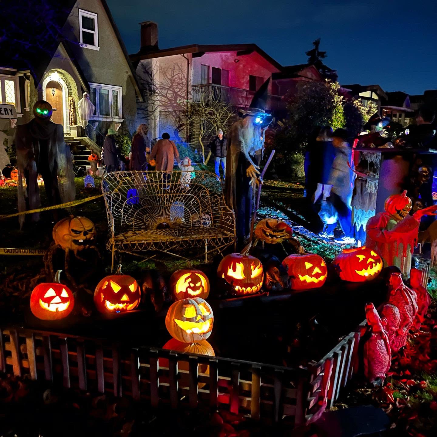 Extensive atmospheric lighting and spooky custom front yard prop displays inside a Vancouver neighborhood house layout