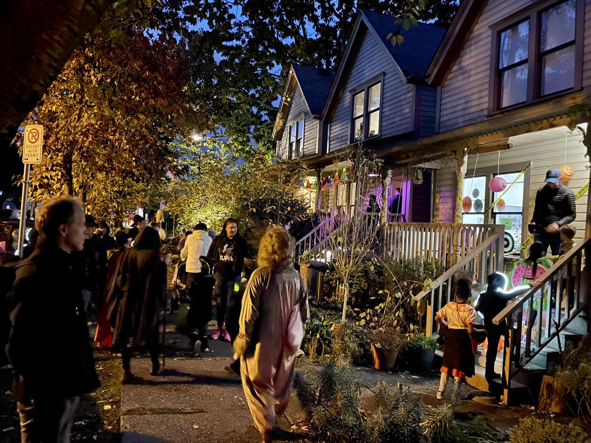 Children in costumes trick or treating on residential streets